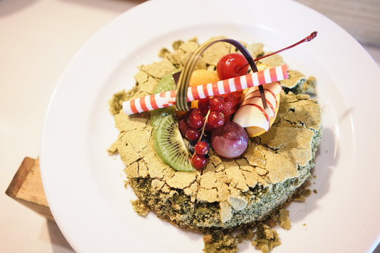 Beautiful Matcha Green tea decorated cake with mix fruits