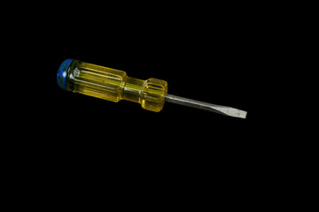 Screwdriver with a yellow and blue handle isolated on a black background