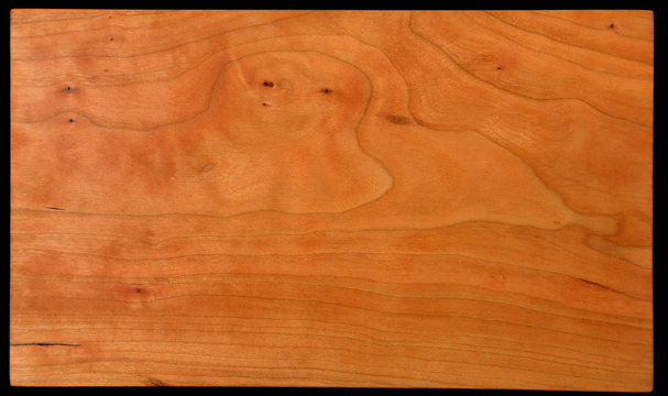 Close-up of hand finished cherry wood with a nice grain pattern