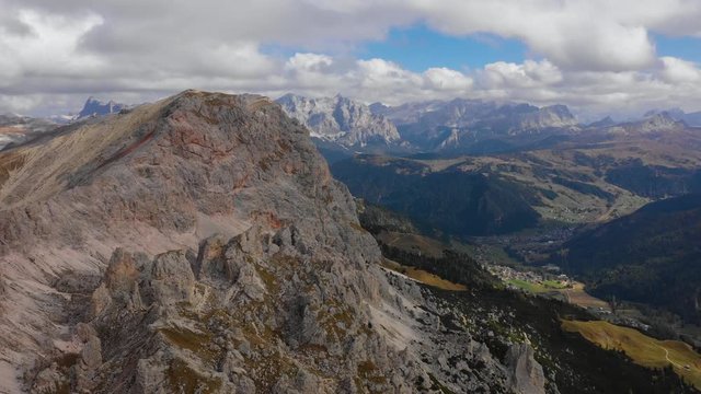 Aerial view of the Paso Gardena Pass in the province of Bolzano. Dolomites. Flying near the Pizes de Cir. In the distant view of a mountain Schelrn. Autumn in Italy