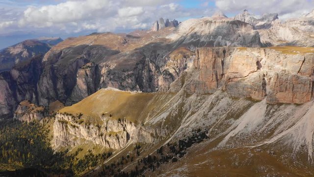 Aerial view of the Paso Gardena Pass in the province of Bolzano. Dolomites. Flying near the Pizes de Cir. In the distant view of a mountain Schelrn. Autumn in Italy