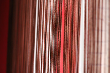 Red striped background with cords