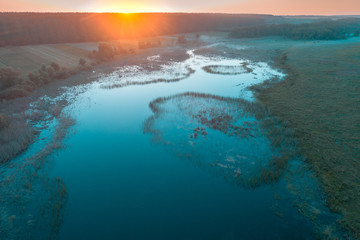 Early foggy morning. Sunrise over the lake. Rural landscape in the summer. Aerial view