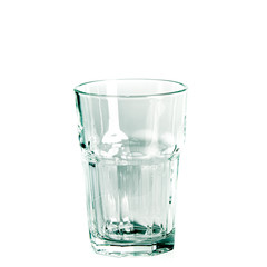 An empty glass and a carafe for water stand on a white background