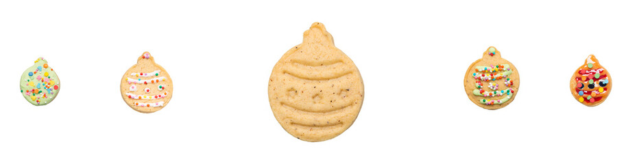 on a white background, sweet cookies in the form of Christmas tree toys, with caramel and colorful sprinkles, laid out in a row