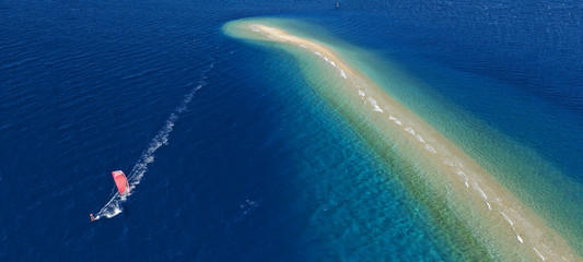Aerial drone ultra wide photo of kite surfer practising in exotic turquoise sand bar