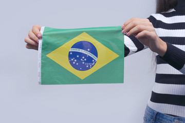 female hands with brazilian flag