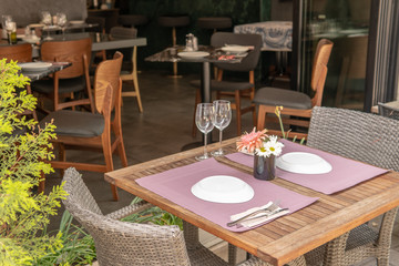 Fancy set table with flowers outside hotel