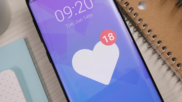 Receiving many like heart notifications on a smartphone. The number keeps rising and rising. Popular social media content concept