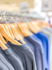 Men's clothing hanging for sale in the shop scene fashion backgrounds