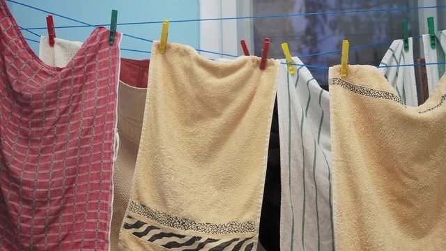 Close up of towels hang from the clothes line indoors
