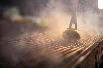 cleaning a grill with an onion ,run the onion along the grates .