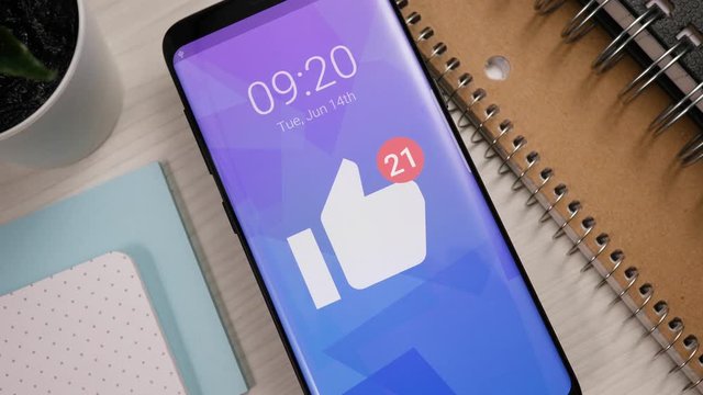 Receiving many likes notifications on a smartphone. The number keeps rising and rising. Popular social media content concept