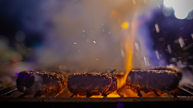 meat grilling on fire with smoke