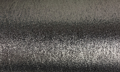 background of silver lurex wool on a cone