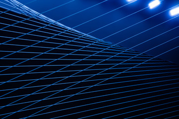 Blue abstract technology, science or business background. Threads and lines of light intersect and create winding geometric forms in perspective