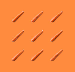 Carrot pattern isolated on orange background. Fresh diet food.