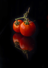 fresh red tomato on black background 