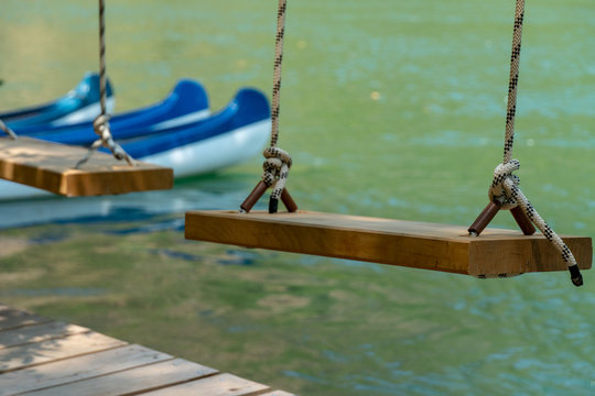 Wooden Swing and Conoe in Background