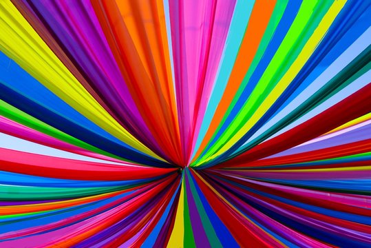Multi color fabric in a row. abstract background colorful rainbow. rainbow background image has radial lines. rainbow cloth background.