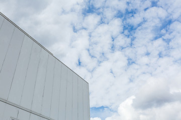 Modern new industrial building, white warehouse building over blue sky