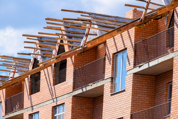 three-storey brick apartment building under construction. Share building.