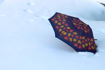 Umbrella on the snow. Сhanging of the climate Concept photo. 