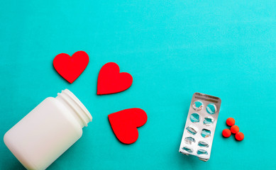 jar of pills, blister empty pills red, three hearts on a blue background,love disease