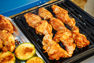 Chicken meat grilling on gas grill