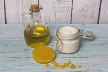 Facial cream of homemade olive oil in glass jar, with pieces of virgin beeswax. Medicine and alternative health.