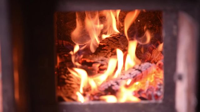Fire in the classic russian bathhouse furnace. Tipical village life