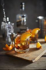 Tasty alcoholic old fashioned cocktail with orange slice.