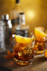 Tasty alcoholic old fashioned cocktail with orange slice.