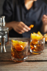Tasty alcoholic old fashioned cocktail with orange slice.