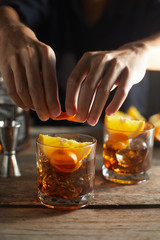 Tasty alcoholic old fashioned cocktail with orange slice.