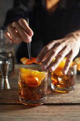 Tasty alcoholic old fashioned cocktail with orange slice.