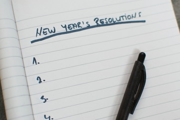 pen and notebook with a list of new years resolutions