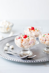 Dessert dishes filled with Ambrosia salad.