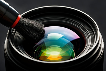 Brush cleaning the camera Lens with a beautiful close-up optical unit.