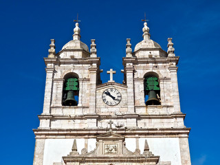 Fototapeta na wymiar City church of Nazare named Nossa Senhora at the Atlantic ocean coast of Portugal