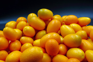 fresh orange citrus Kumquat fruit isolated on a black background