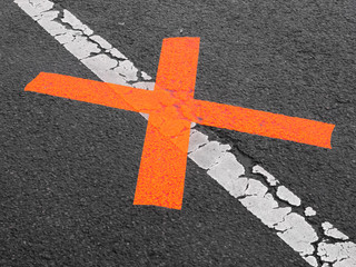 red x on white line asphalt no parking
