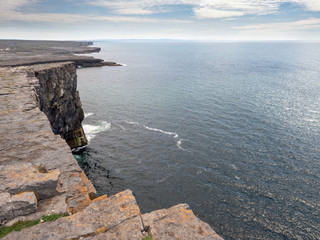 View from a cliff, Inishmore, Aran islands, Ireland, Cloudy sky, Atlantic ocean.