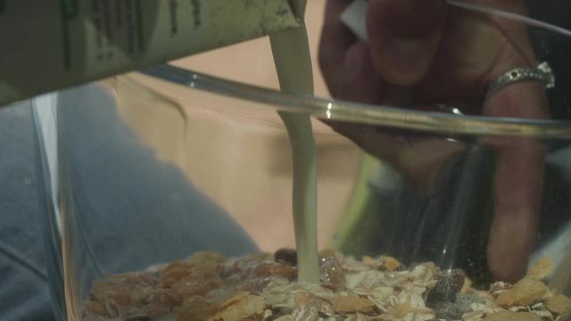 Pouring Milk Into Breakfast Cereal, Outdoors Camping Closeup.