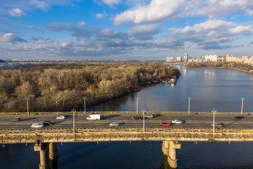 Beautiful Aerial View of City Traffic on the Bridge at the Sunny Day in winter.