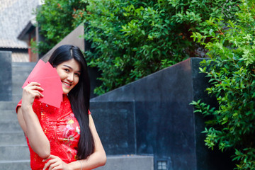 Beauty women wearing cheongsam holding red paper money envelopes Happy Chinese New Year Festival