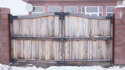 Wooden gate with iron upholstery