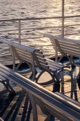 Empty rows of benches on passenger boat traveling the Greek Islands with no passengers