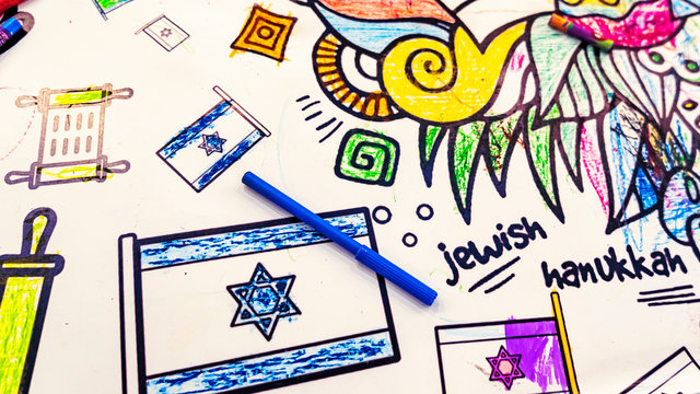 Childrens drawing of flag of Israel with the blue pencil and inscription JEWISH and HANUKKAH. Hannukah and jewish concept and symbol.