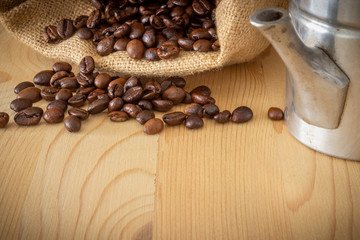 Neapolitan coffee machine, coffee beans and burlap sack on wooden background